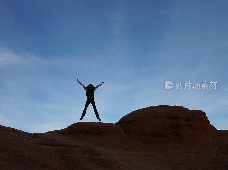 Jumping Mid-air Person Silhouette, Curved Rock Formation